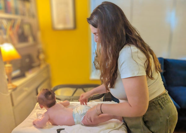 Baby enjoying a stimulating massage from Mum
