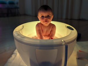 Spa Whirlpool Baths - baby sitting in a lit-up bath