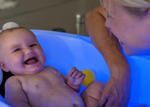 Smiling baby in whirlpool bath