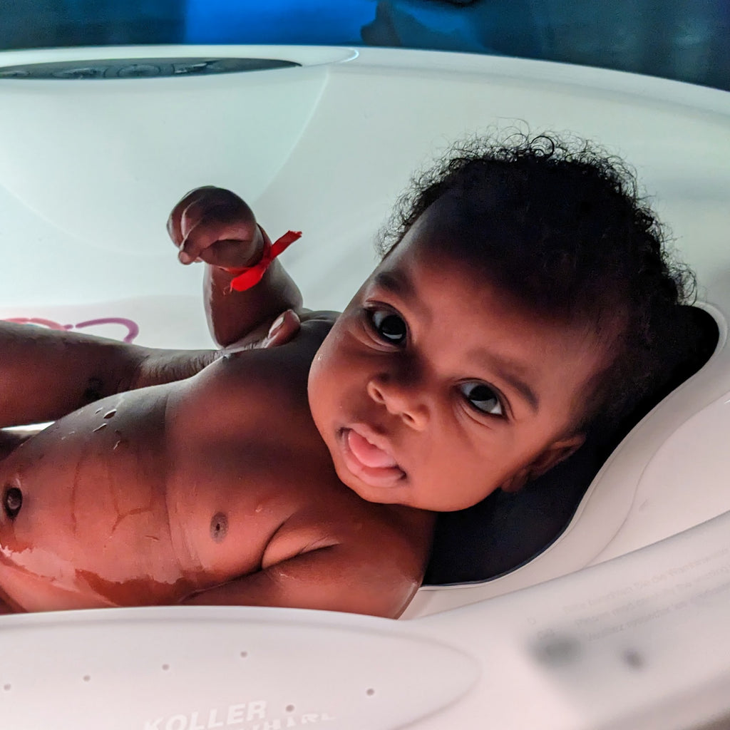 Relaxed baby in a whirlpool spa bath